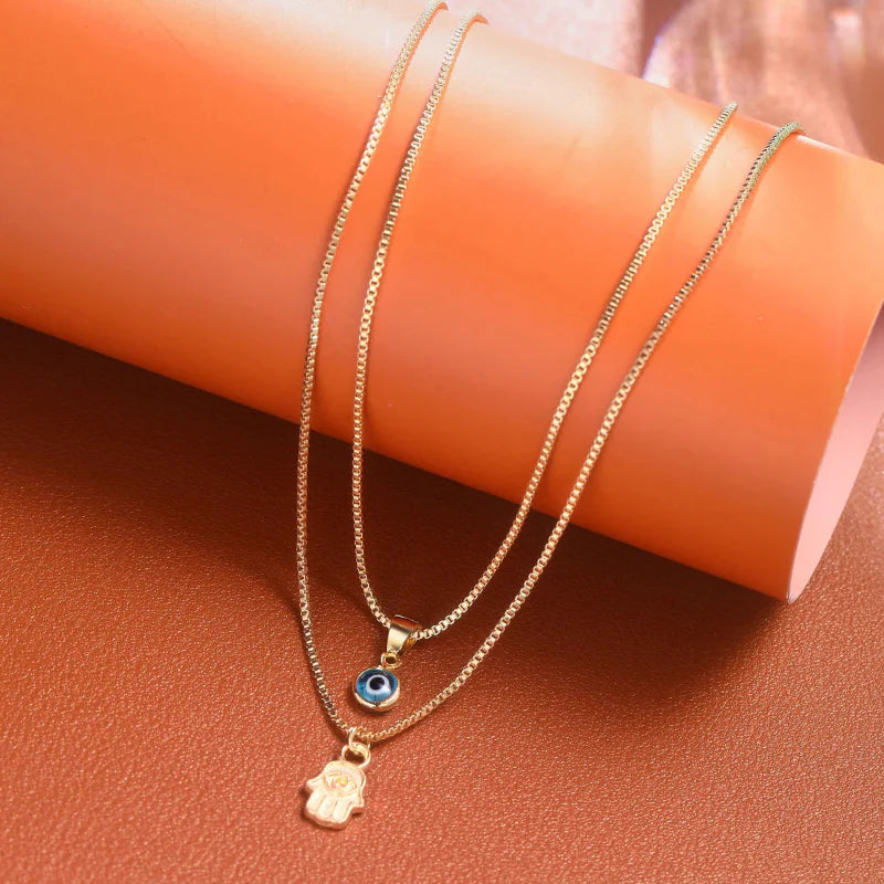 Collar Doble con Colgante Ojo Azul Turco y Mano de Fátima oro