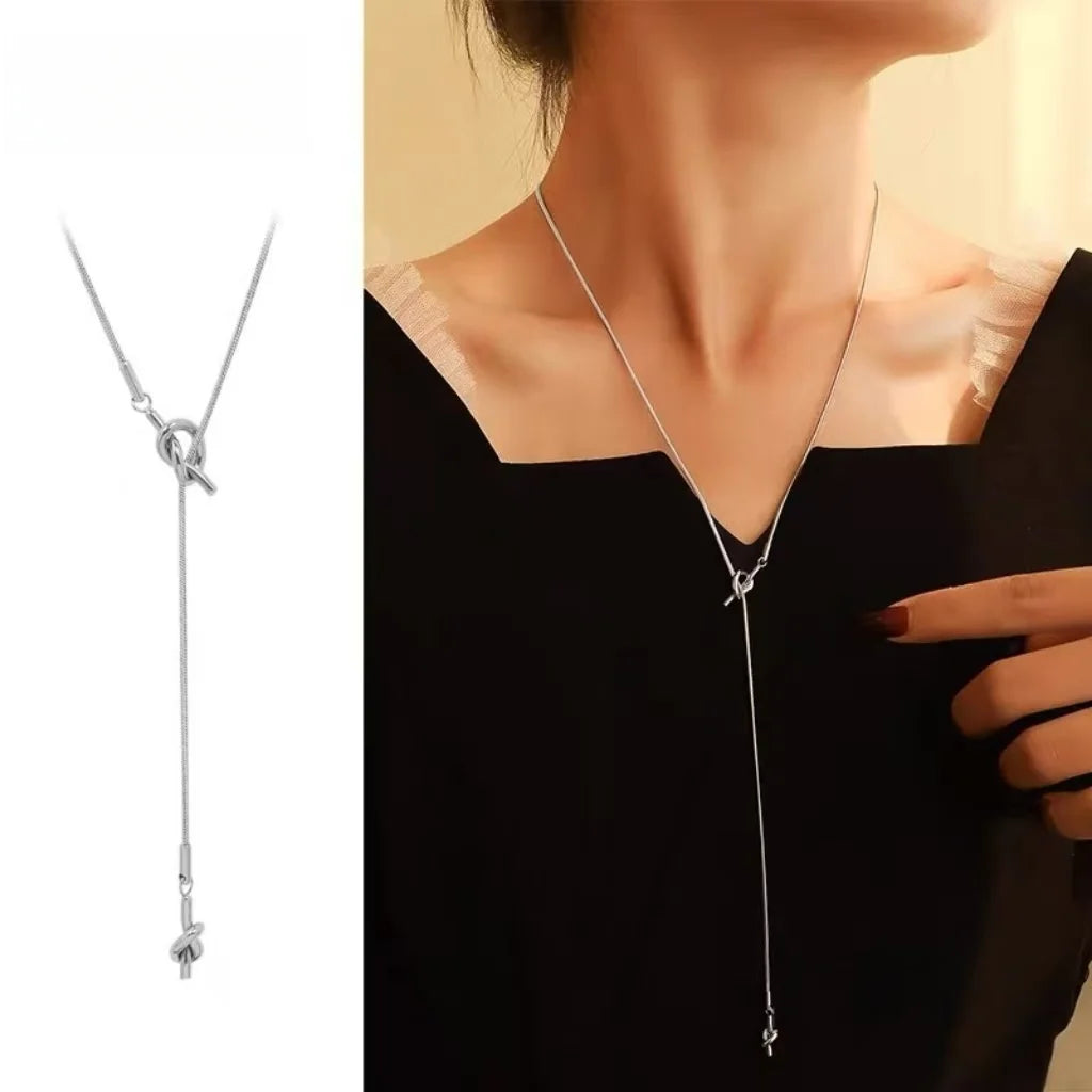 Long collier de décolleté avec pendentif noeud