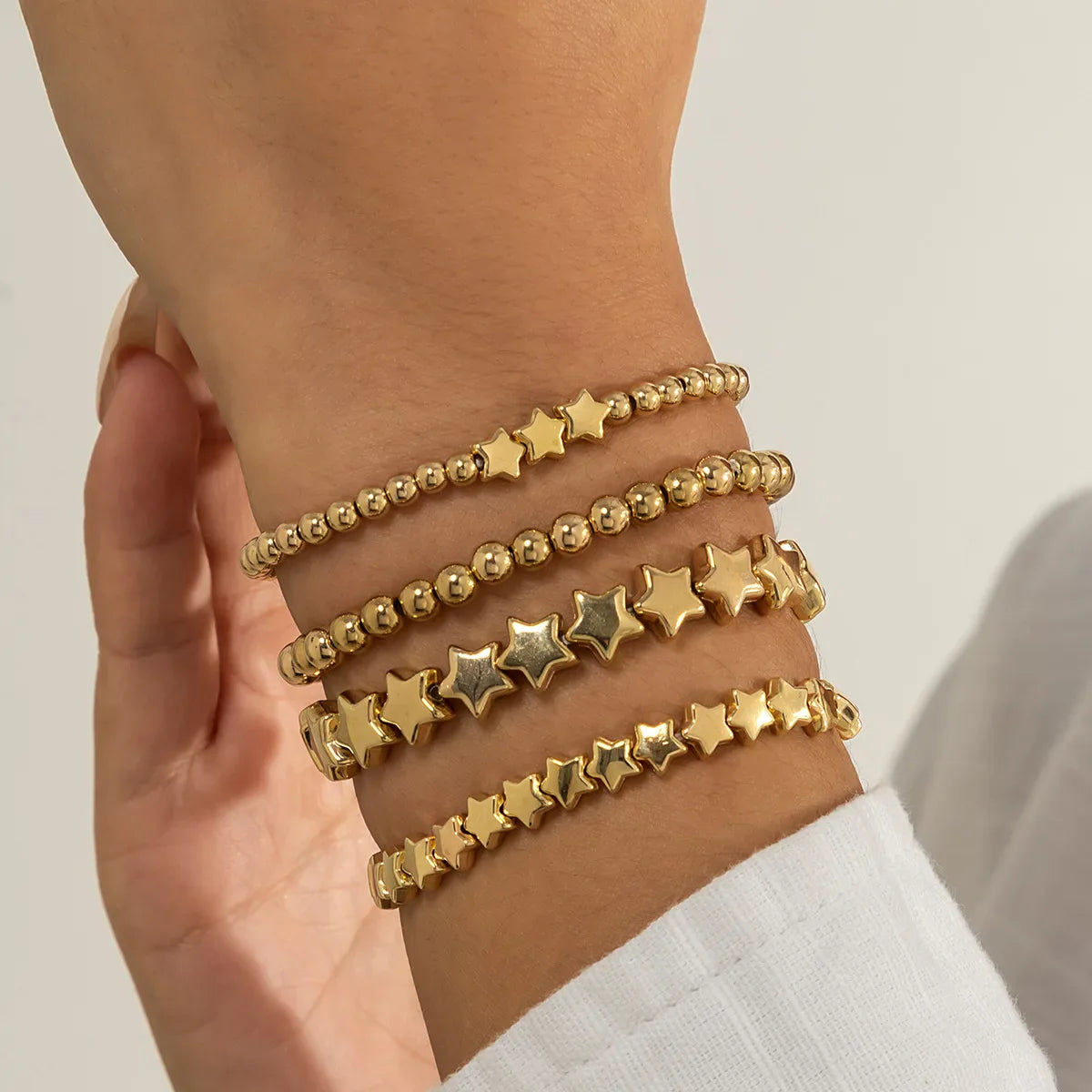 Lote de 4 Pulseras Estrellas oro